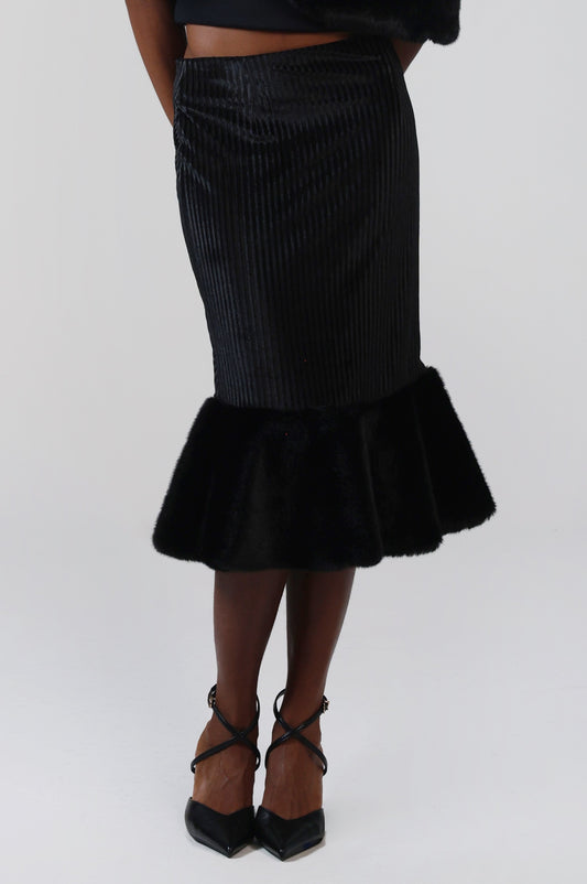 Close-up of the black velvet midi skirt, showing the ribbed velvet and full faux fur flounce