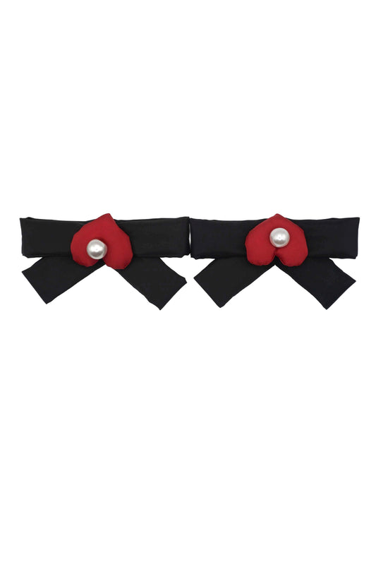 Pair of lacquer black bow charms, each centered with a red mamu heart logo and a pearlescent bead