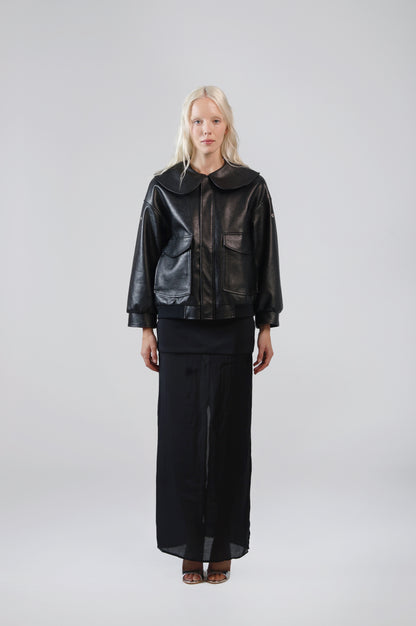 Jinnoir black faux leather jacket with an oversized Peter Pan collar, front view on model