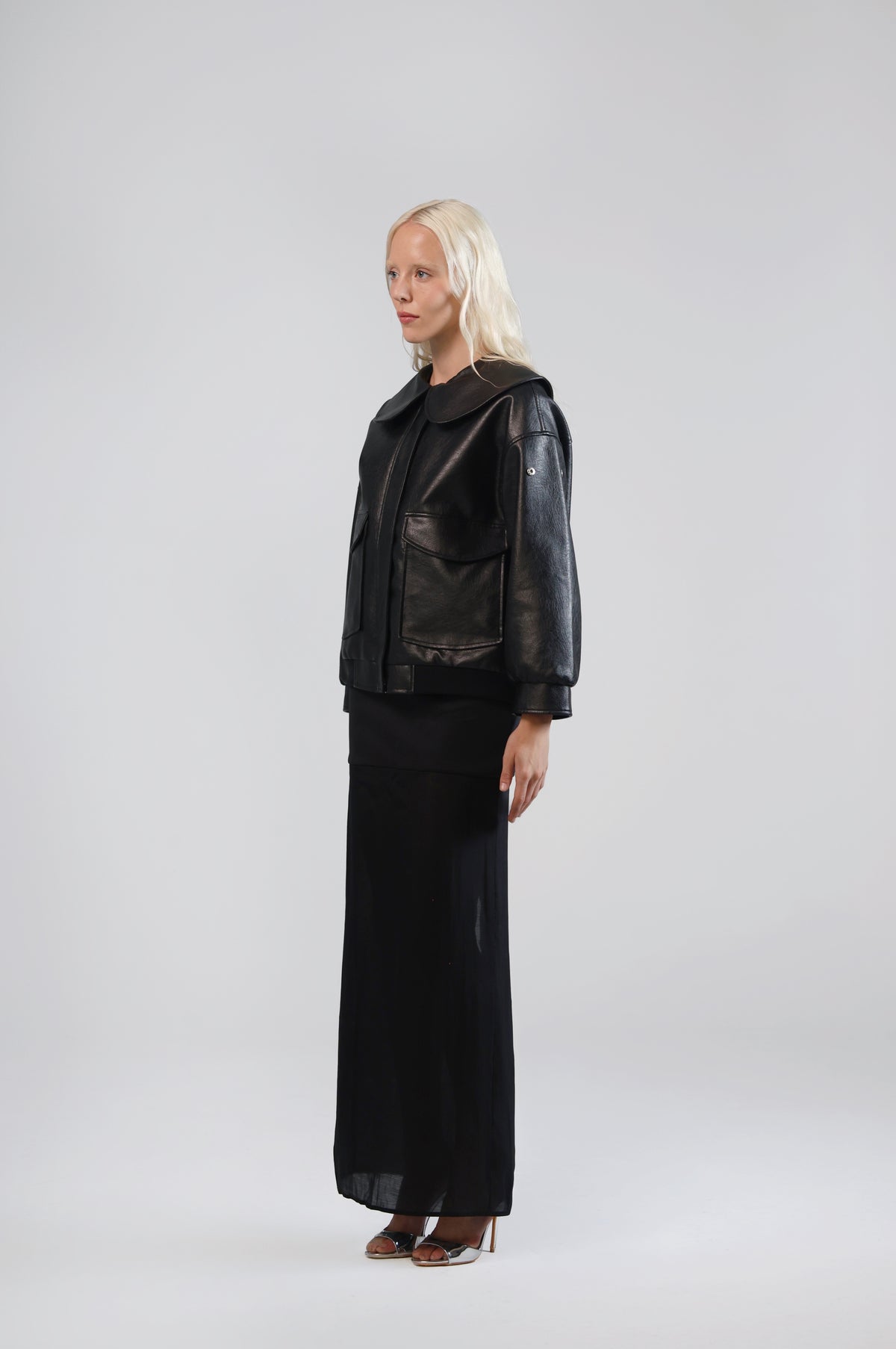 Jinnoir black faux leather jacket, side view on model