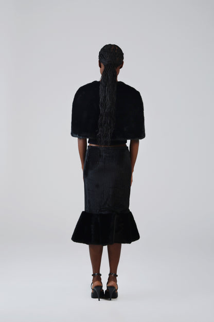 Black velvet midi skirt with faux fur flounce, back view on model