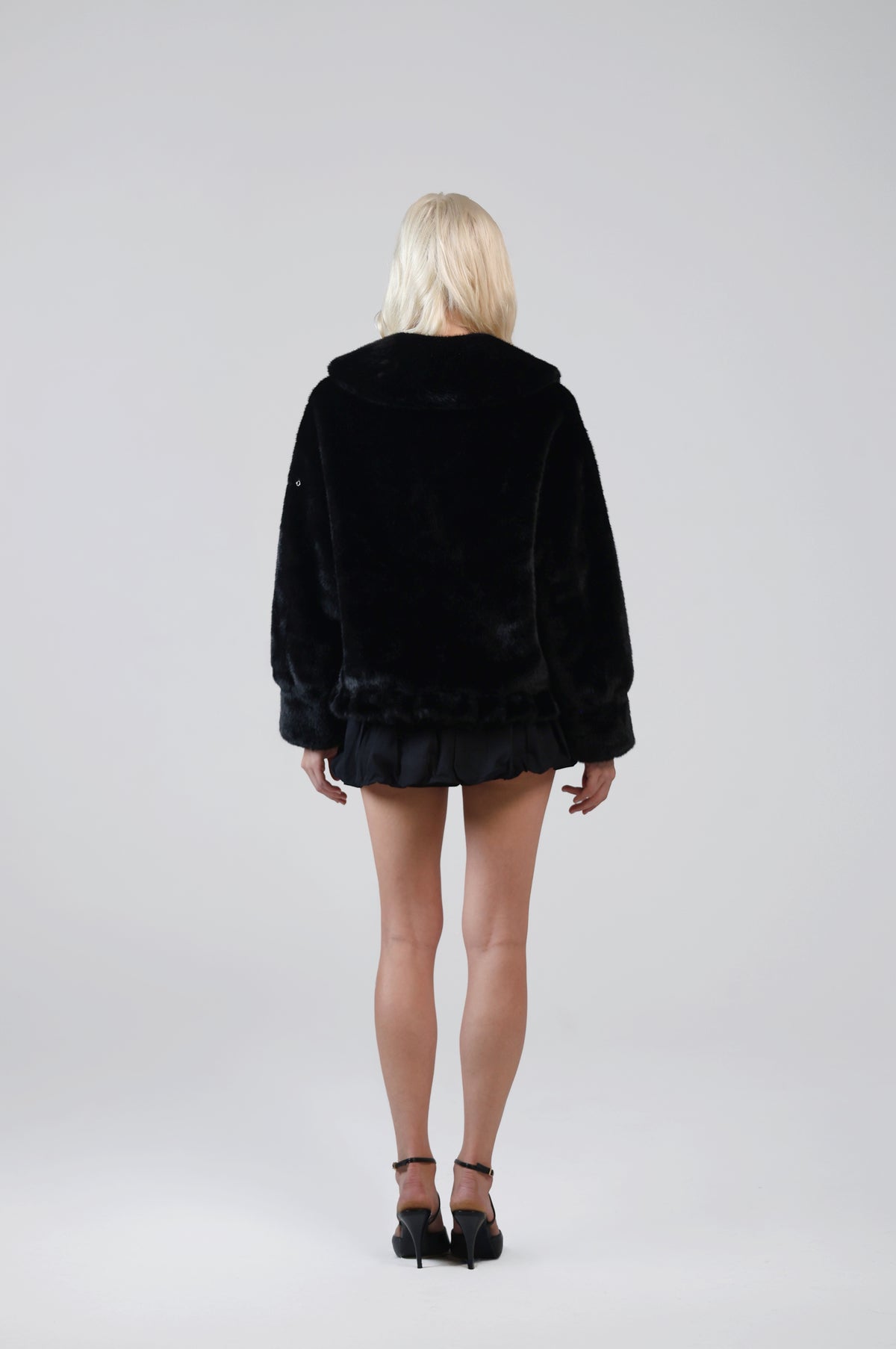 Jinnette black faux fur jacket, back view on model