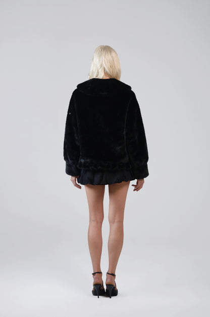 Jinnette black faux fur jacket, back view on model
