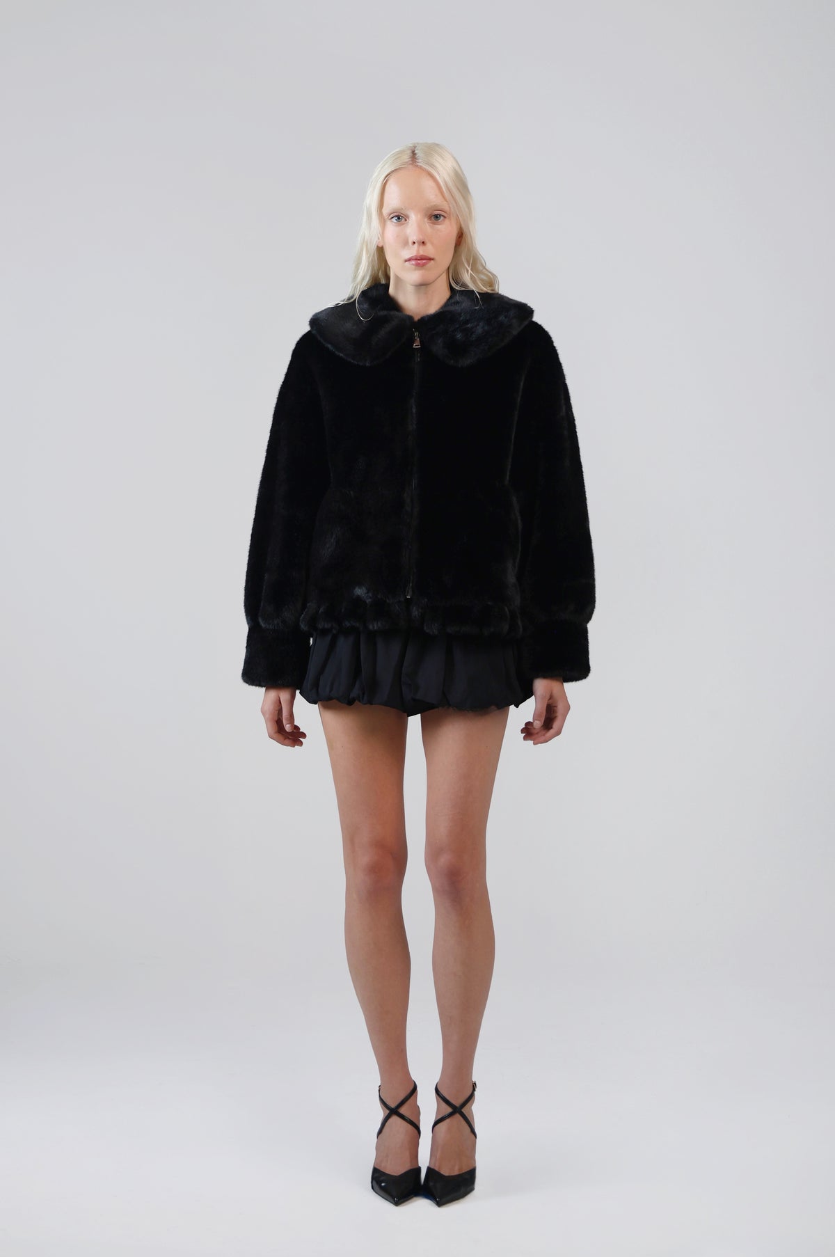 Jinnette black faux fur jacket with an oversized Peter Pan collar and front zip, front view on model
