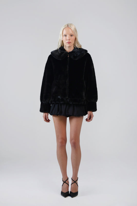 Jinnette black faux fur jacket with an oversized Peter Pan collar and front zip, front view on model