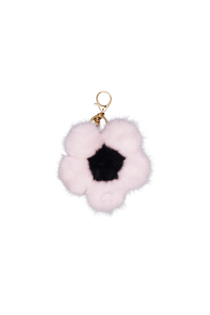 Single sakura pink faux fur flower charm on a metal keychain, worn as a bag charm
